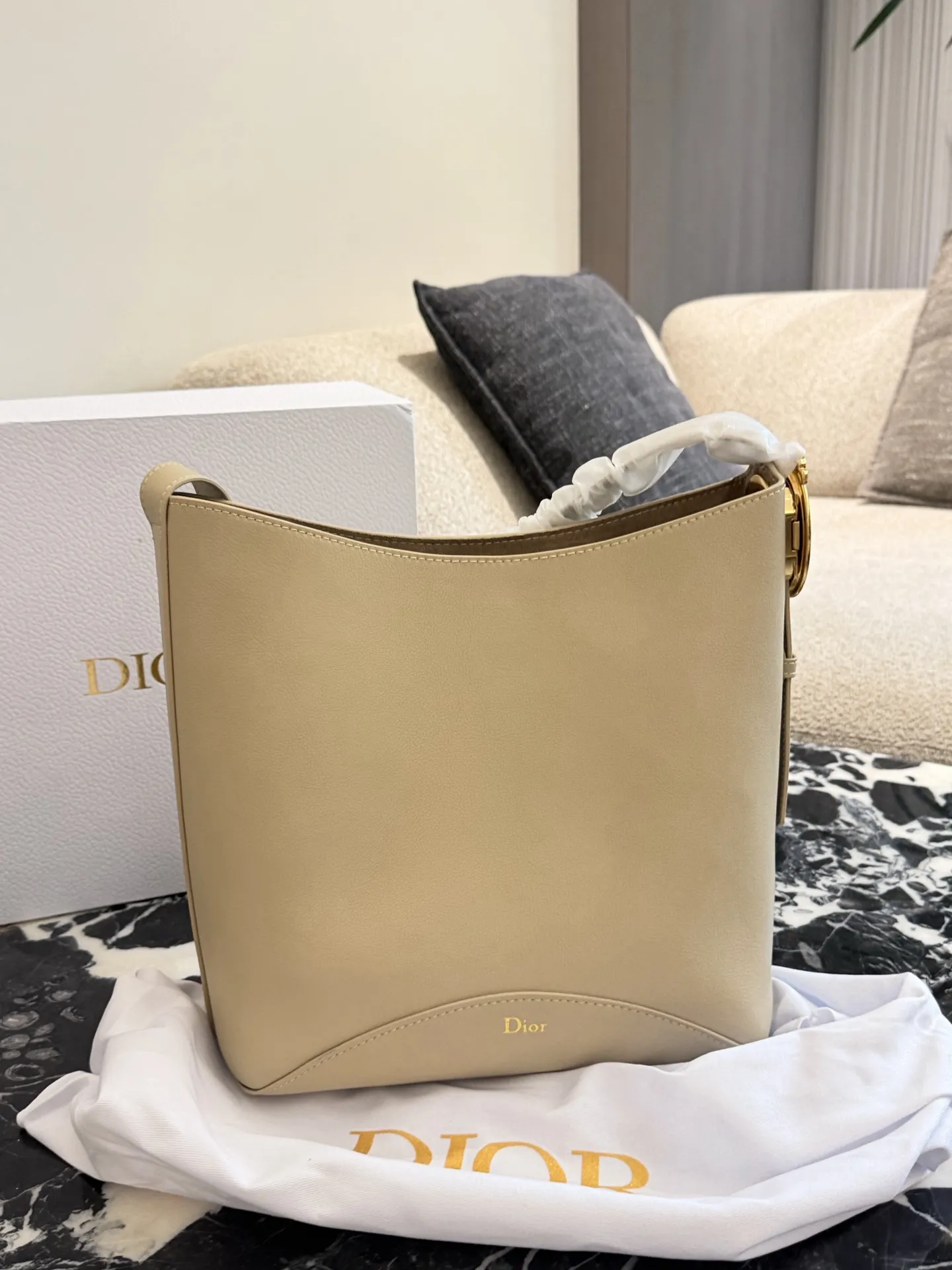p250 Dior Diorbook手袋 👜Dior Diorbook手袋采用优质小牛皮,触感细腻耐用,浅米色搭配白色褶皱肩带,简约优雅✨。弧形包身线条流畅,正面“Dior”标志低调精致。肩带可调节,支持手提或斜挎,日常通勤、休闲出行都很百搭。内部空间宽敞,手机、钱包、化妆品轻松收纳,实用又时髦,是Dior经典系列热门款!25×30