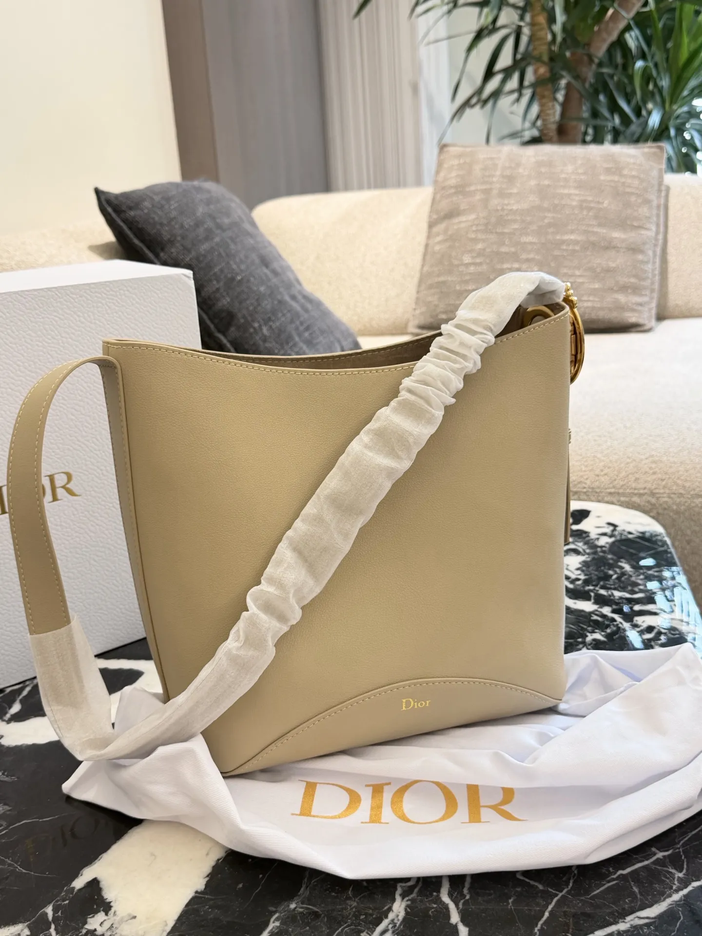 p250 Dior Diorbook手袋 👜Dior Diorbook手袋采用优质小牛皮,触感细腻耐用,浅米色搭配白色褶皱肩带,简约优雅✨。弧形包身线条流畅,正面“Dior”标志低调精致。肩带可调节,支持手提或斜挎,日常通勤、休闲出行都很百搭。内部空间宽敞,手机、钱包、化妆品轻松收纳,实用又时髦,是Dior经典系列热门款!25×30