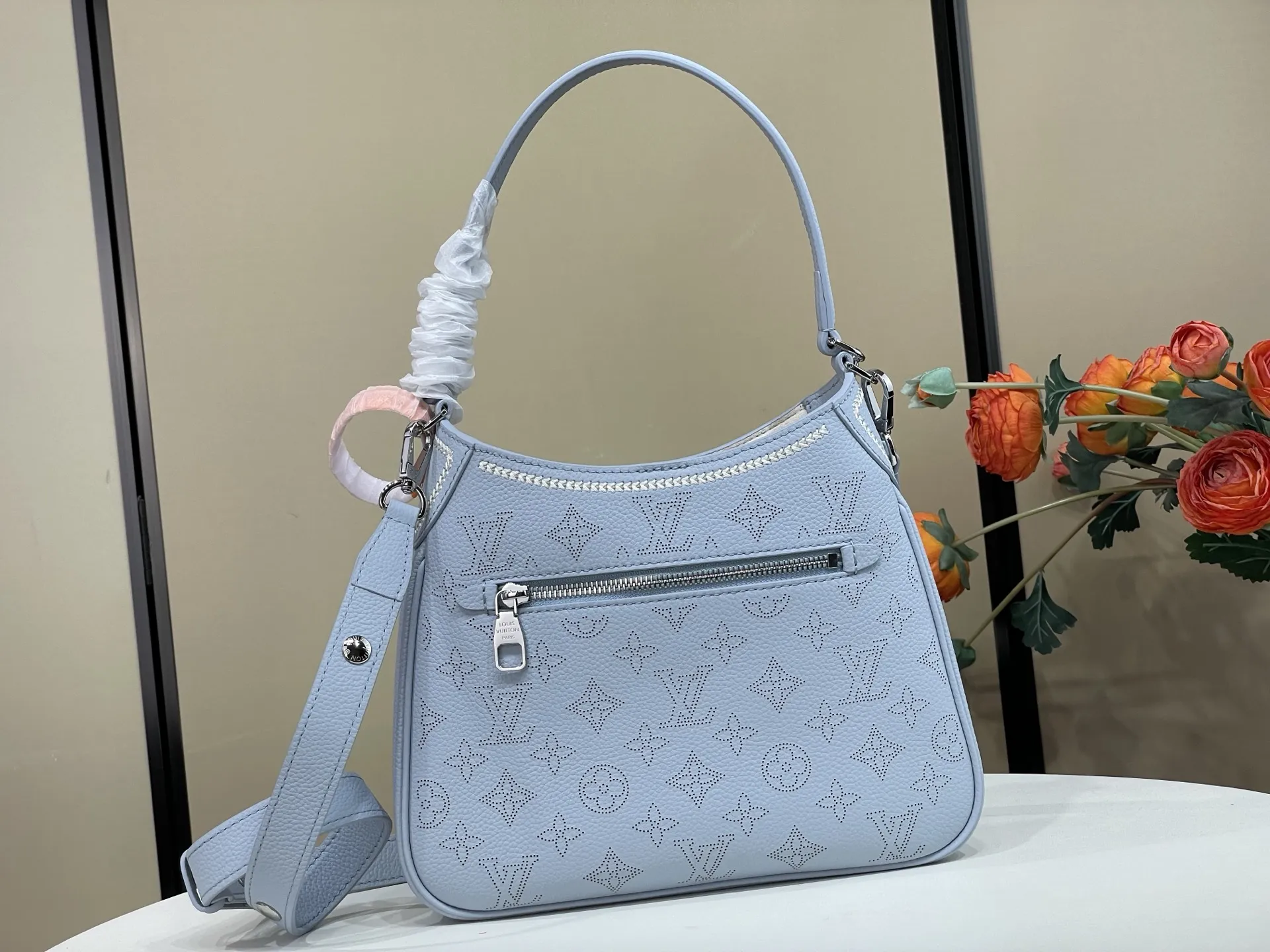 复刻独家实拍📷【ALL AROUND 小号手袋 】 m28779 蓝色（冲孔） Mahina Couture 系列以优雅色调重绎 All Around 小号手袋，再为牛皮革铺陈Monogram 穿孔图案，与编织纹理刺绣细节共筑色彩反差。标志性 LV 挂锁点睛考究构型，可调节肩带提供多种背携方式。 尺寸：25 x 20 x 6 厘米 (长度 x 高 x 宽)
