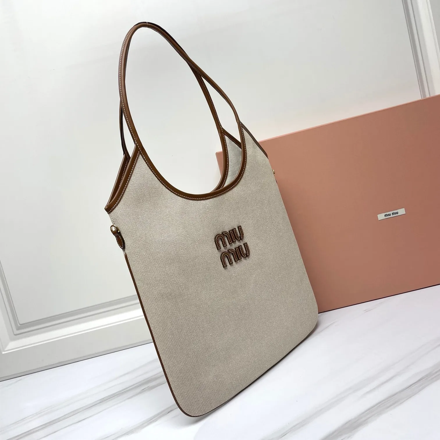 🍒M家🍒 5BG231，Miu家新款伊势丹限定托特包，全新帆布面料，延续上一季的慵懒和性感热潮，大胆创新的设计完美诠释了 Miu不拘一格，潇洒随意包容的人生态度，今年绝对爆🔥款式，搭配顶级进口小牛皮，质感高级，包身软而不塌，气质随性慵懒，容量超大，日常出街背它回头率百分百，手工缝制皮面Logo标志，内里全新麻布里，配拉链式口袋，尺寸35 X 40Cm，配原版包装