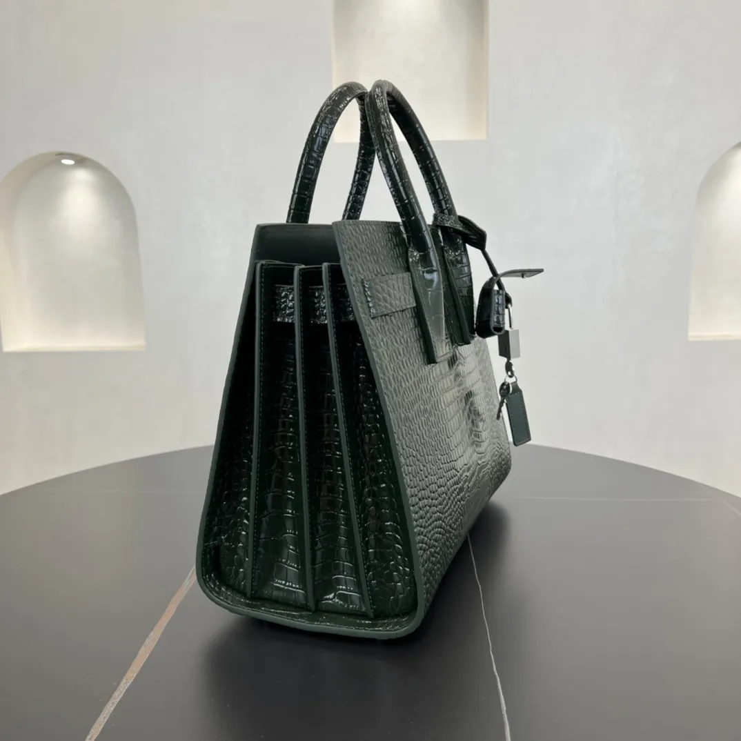 经典 SAC DE JOUR 大号鳄鱼纹压花闪亮真皮手袋经典 SAINT LAURENT 手袋，管状提手，侧面手风琴式皱褶，松紧调解皮带附吊牌，镌刻 SAINT LAURENT 标志，可拆卸肩带。货号 378299 💰1020 尺寸 32.0 25.0 16.5 CM100% 小羊皮革衬里银色调五金可拆卸皮革外包挂锁可拆卸中央拉链袋铜脚臂垂：9.5 CM肩带垂饰：48 CM