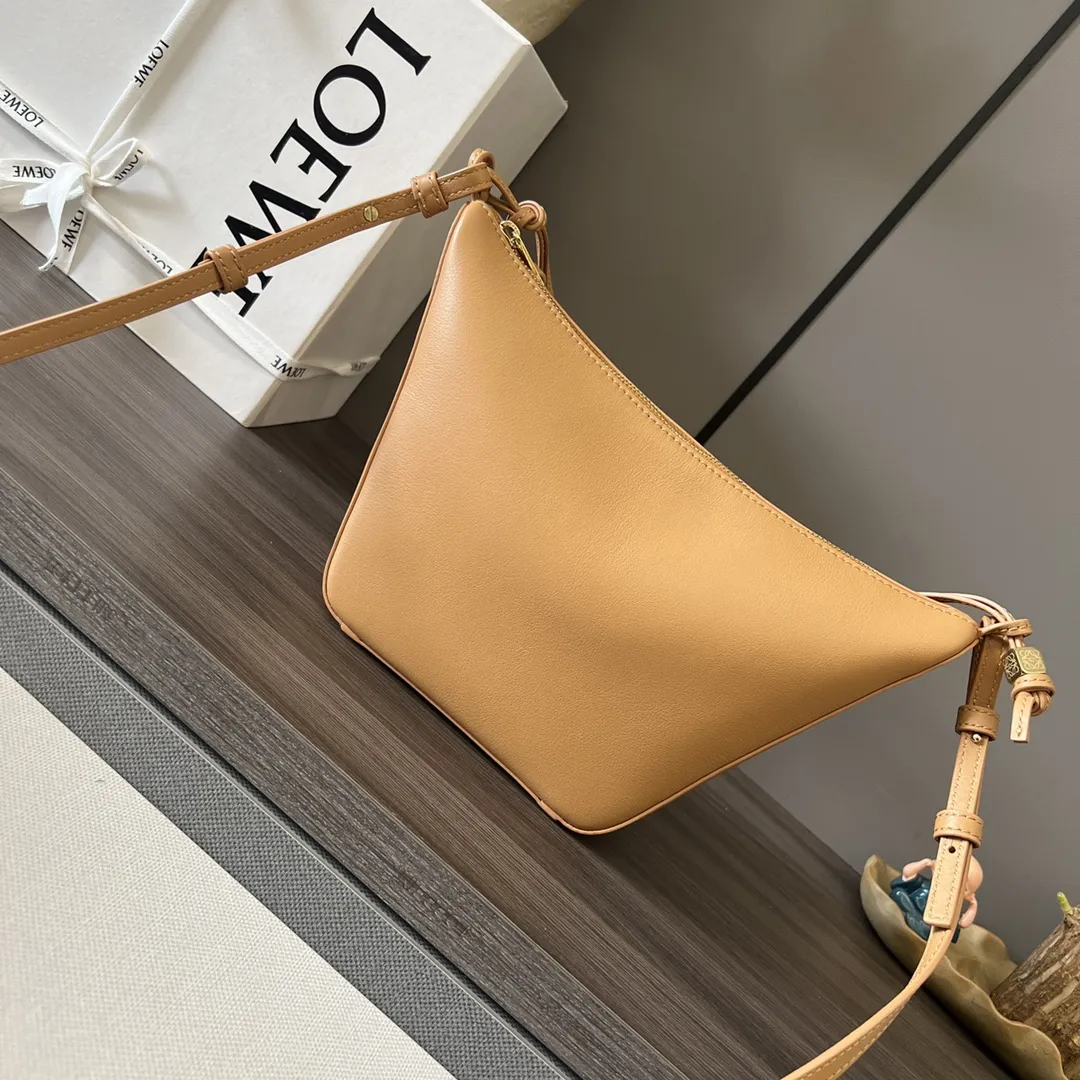 LO℮w℮🌟经典牛皮革Hammock hobo手袋 将经典手袋能轻松改变形状的设计进行解构，保留颇具代表性的吊床造型，打造出一款时尚百搭且符合人体工学的hobo手袋.此迷你版本采用经典牛皮革制成，打结牛皮革带子可进行个性化设计。*可肩背、斜背或手提*拉链开合*牛皮革拉链头*骰子🎲挂饰*人字纹棉质帆布衬里* size:28*17*9.5CM 型号：262315 F：630（配全套包装）